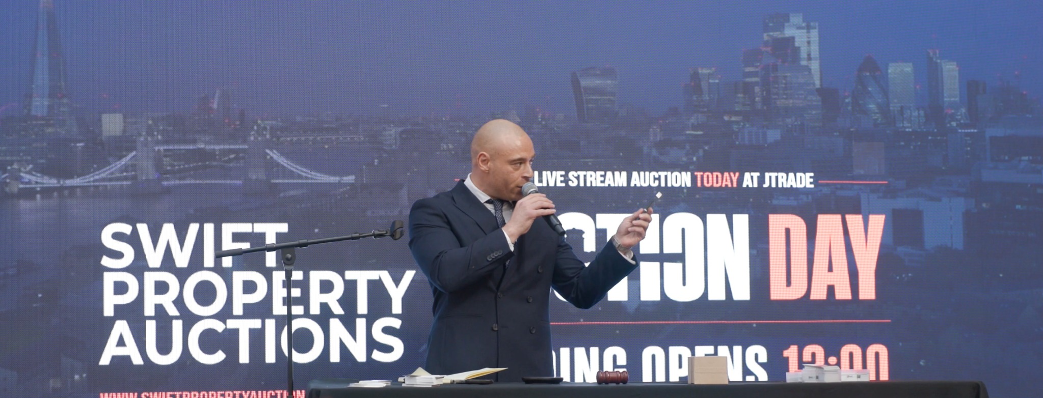 Swift auctioneer speaking at the Swift auction event